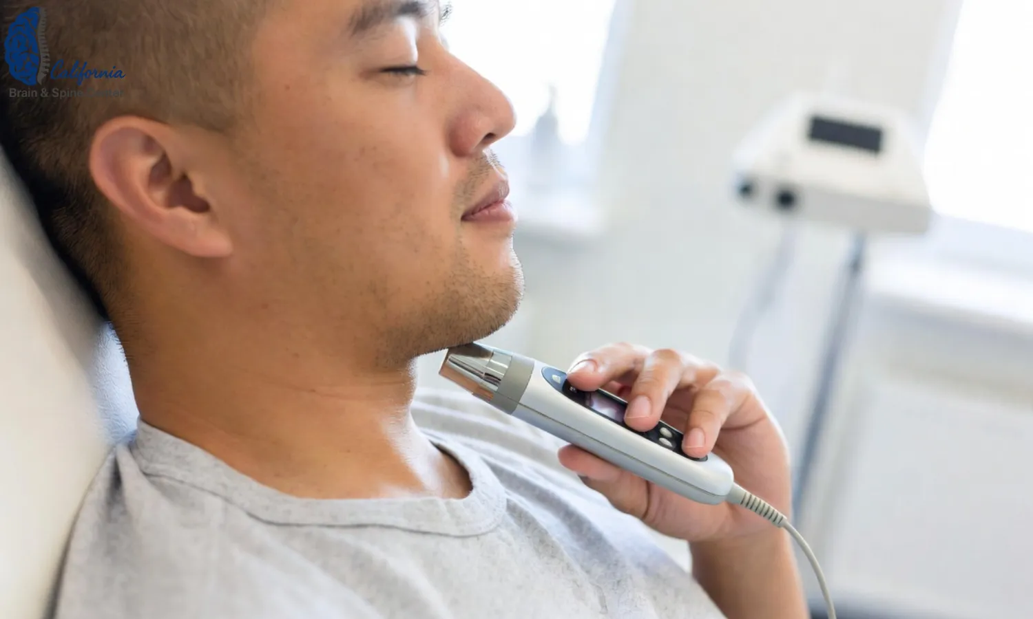 Close up of a patient receiving non invasive vagus nerve stimulation with a handheld device, eyes closed, seated comfortably in a bright modern neurology clinic.